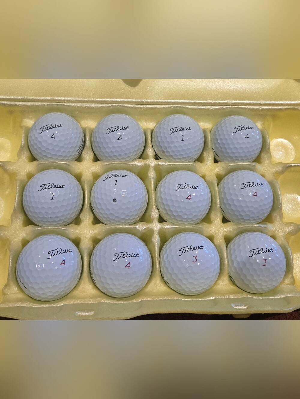 12 Titleist ProV1 white golf balls.  Pristine playing condition. No logos.